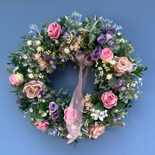 Load image into Gallery viewer, Floral wreath with pink and purple flowers on a blue background